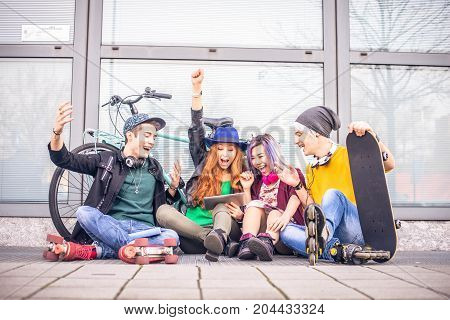 Multi-ethnic group of students stdying together outdoors in a college campus