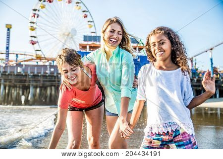 Lesbians mothers with adopted child - Happy homosexual family playing with her daughter