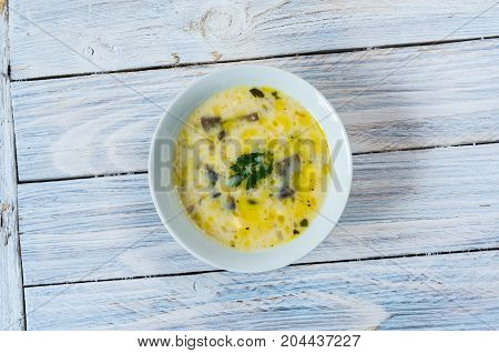 Soup With Mushrooms And Butter. White Plate On A White Background.