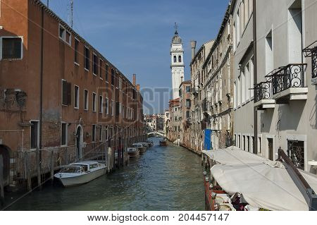 Traditional gondola ride in small canal at residential district of historical buildings and bridge, Venezia, Venice, Italy, Europe