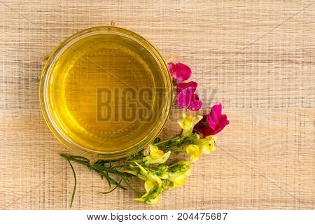A Cup Of Honey On The Plate. The Honey In The Spoon Drops, Raspberry, Chamomile, Derevyanny Backgrou