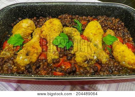 Fried in the oven crispy chicken legs with gray peas.