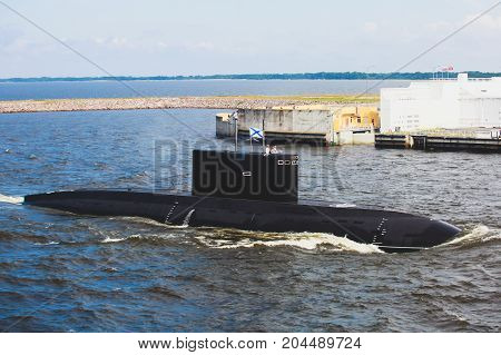 A line of modern russian military submarine cruisers in the row, northern fleet and baltic sea fleet in the open sea, submarine
