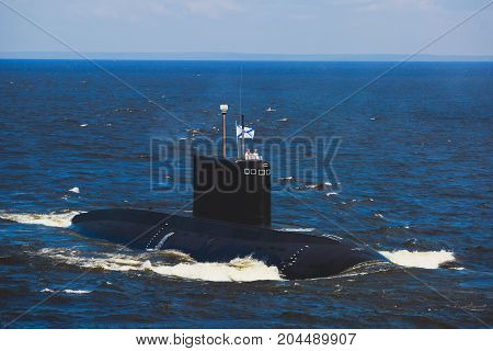 A line of modern russian military submarine cruisers in the row, northern fleet and baltic sea fleet in the open sea, submarine