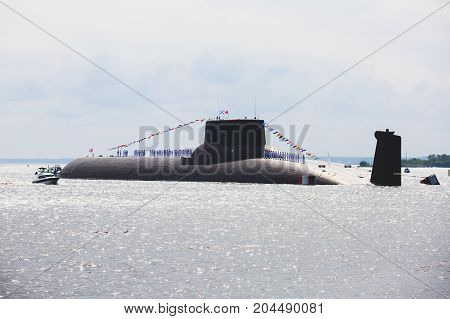 A line of modern russian military submarine cruisers in the row, northern fleet and baltic sea fleet in the open sea, submarine
