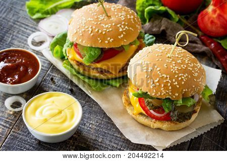 A Double Burger With A Meat Cutlet And Vegetables Is Served With Cheese Sauce And Ketchup. Delicious
