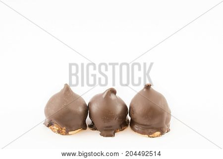 Three cones of dulce de leche and chocolate in a row. White background.