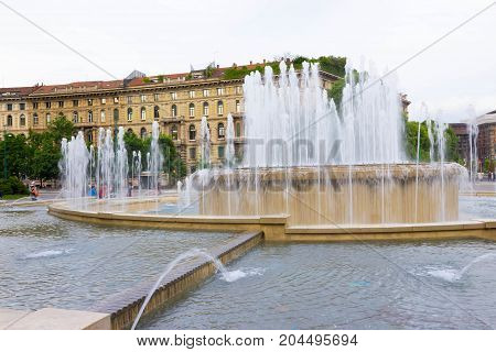 The fountain on place at Sforza Castle in summer day. Milan, Italy