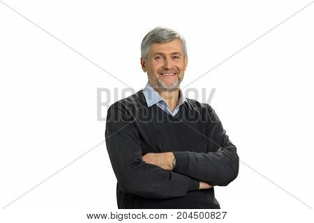 Smiling mature man with crossed arms. Cheerful senior man with crossed arms on white background.