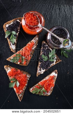 Red And Black Caviar In Small Silver Spoon On A Wood Background With Black Bread ,food Concept