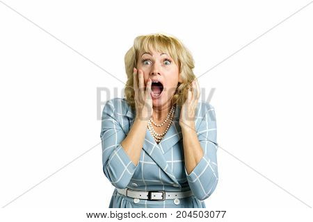 Surprise astonished middle aged woman. Surprise astonished white-skin woman. Close up portrait of mature woman looking surprised in full disbelief with open mouth and hands near face.
