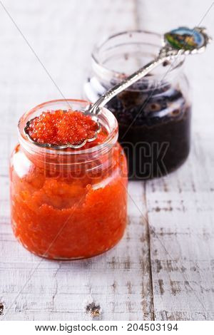 Red And Black Caviar In Small Silver Spoon On A Wood Background With Black Bread ,food Concept