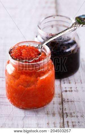 Red And Black Caviar In Small Silver Spoon On A Wood Background With Black Bread ,food Concept