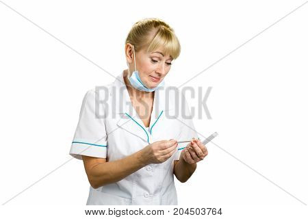 Mature medical doctor with thermometer. Middle aged blond nurse surprisely looking on termometer isolated on white background.