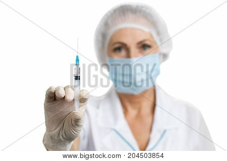 Professional nurse with injection. Close up of syringe in female doctor hand on white background.