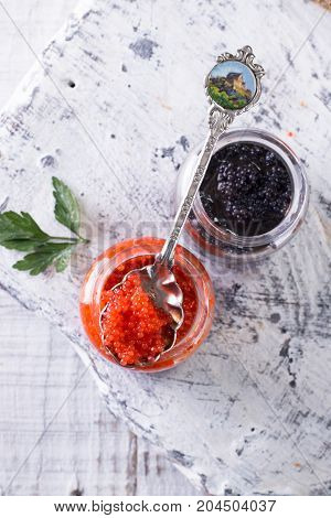 Red And Black Caviar In Small Silver Spoon On A Wood Background With Black Bread ,food Concept