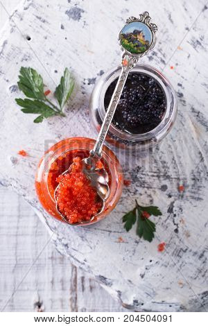 Red And Black Caviar In Small Silver Spoon On A Wood Background With Black Bread ,food Concept
