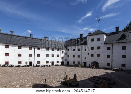 TURKU, FINLAND ON JUNE 30. Outdoor view of the Turku Medieval Castle from the 13th century on June 30, 2017 in Turku, Finland. Classical stone building. Unidentified people. Editorial use.