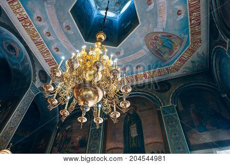 Dnipro Ukraine - August 06 2017: Church of St. Nicholas large gold or bronze chandelier in the temple or cathedral big bronze with handelier in the church orthodox church inside