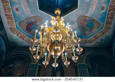 Dnipro Ukraine - August 06 2017: Church of St. Nicholas large gold or bronze chandelier in the temple or cathedral big bronze with handelier in the church orthodox church inside