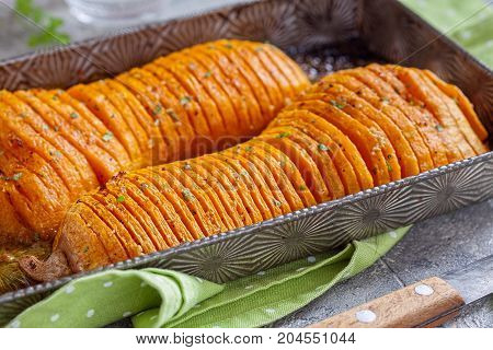 Roasted hasselback butternut squash pumpkin with garlic