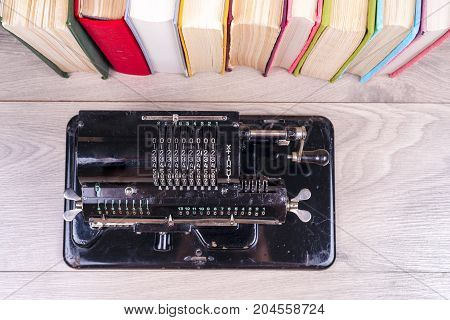 Old Rusty Retro Calculator Black Standing On A Wooden Table