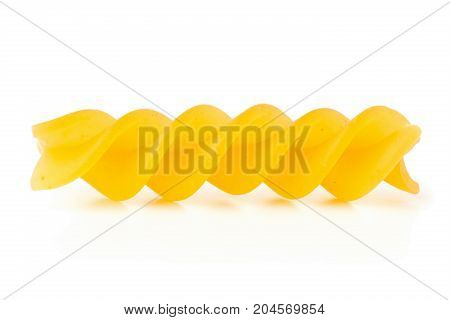 Closeup of raw uncooked dry fusilli or rotini pasta noodle with selective focus on white background