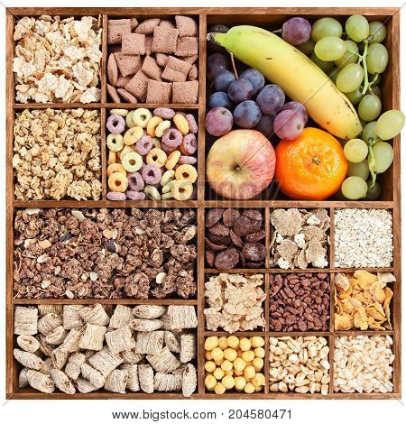 assorted cereals in wooden box with fresh fruits (manual focus)