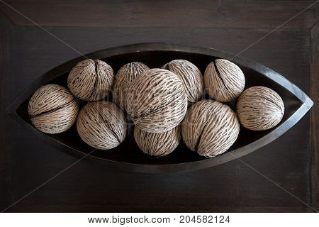 tropical house decoration with pong pong seeds on a tray