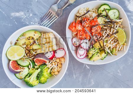 healthy lunch buddha salad bowls ahi poke. concrete background healthy vegan trend food concept.