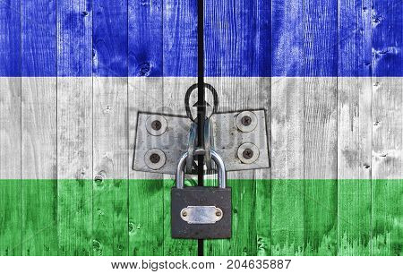 Lesotho flag on door with padlock close