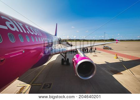 Gdansk Poland August 24 2017: People are boarding to the aircraft of Wizz Air at the airport of Lech Walesa