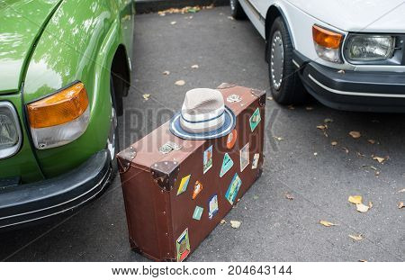 White hat on a brown suitcase .