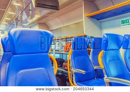 Interior Of The High-speed Train Stand On Railways Stantion. Nobody Inside.
