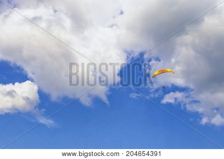 Skydiver in the clouds. Bright sports background