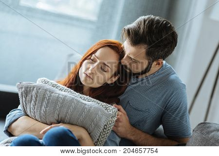 We will deal with it. Sad unhappy cheerless couple sitting together and thinking about their problems while feeling depressed