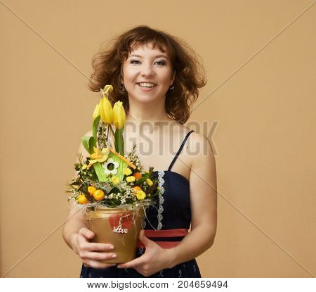 Smiling young woman with flowers. Fly. Birthday