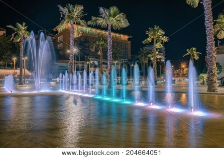 ALBANIA DURRES - September 22 2015: Evening central square with fountains colorful illumination