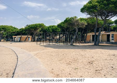ALBANIA GOLEM- September 20 2015: One-storey bungalows on the sandy beach of the Adriatic Sea surrounded by forests.