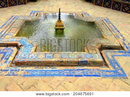 a magnificent foutain garden of la cruz ( seville spain )