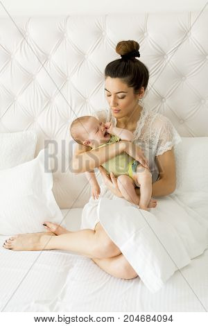 Young Mother Holding Her Litle Crying Daughter