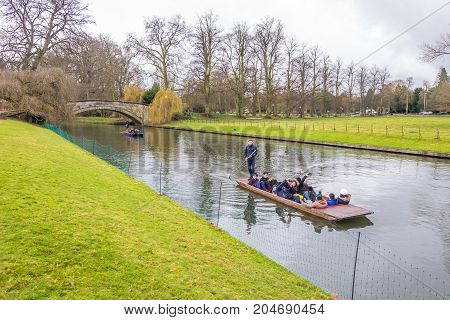 Oxford UK - December 21 2016 : Unidentified people in a boat over the river Cherwell near university of Oxford botanic gardens Oxford United Kingdom.