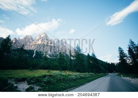 Beautiful sunset over high altitude mountain road next to famous peak in italian dolomites Tre Cime de Lavaredo famous for rocky formations and snow in summer