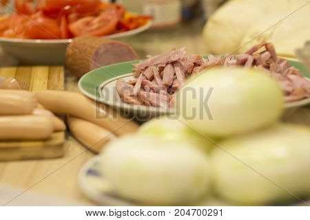 ingredients for the pizza and lay the table