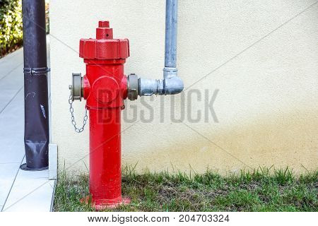 Old red fire hydrant in the street. Fire hidrant for emergency fire access .