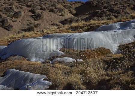 Cascade of frozen water on a hillside in Lauca National Park on the altiplano of northern Chile