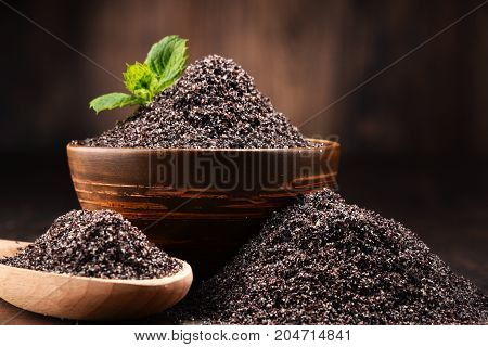 Composition With Bowl Of Poppy Seeds On Wooden Table