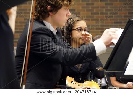 ROMEOVILLE, ILLINOIS / UNITED STATES - MAY 21, 2017: Violinists of the Metropolitan Youth Symphony Orchestra (MYSO) perform music in a concert in Borromeo Hall at Lewis University.