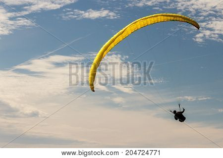 A para-glider up in the sky during a fly surrounded by the clouds