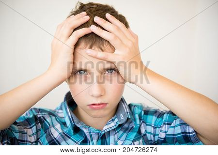 Handsome teen boy holding his hands behind his head